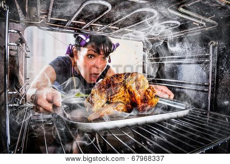 Funny Housewife overlooked roast chicken in the oven, so she had scorched (focus on chicken), view from the inside of the oven. Housewife perplexed and angry. Loser is destiny!