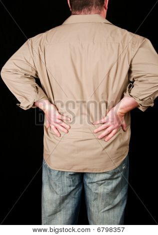 Male With Back Pain On Black Background