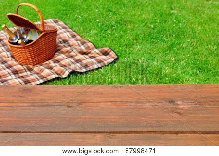 Picnic  Tabletop Close-up. Picnic Basket And Blanket On The Lawn