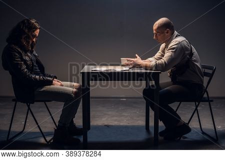 A Police Detective Suspects A White Man Of Committing A Crime. Conducts An Interrogation With The Pr