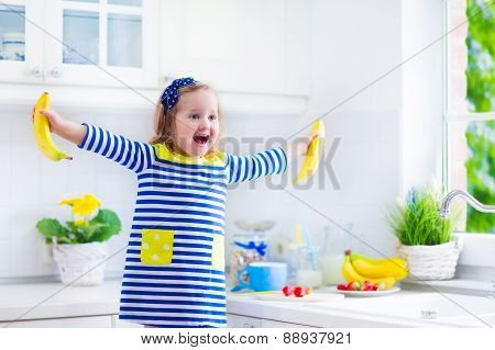 Little Girl Preparing Breakfast In A White Kitchen