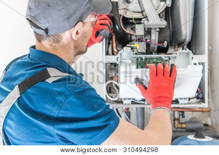 Heating Central Gas Furnace Issue. Technician Trying To Fix The Problem With The Residential Heating