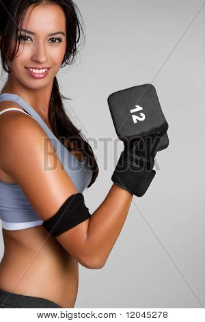 Fit exercising woman lifting weights