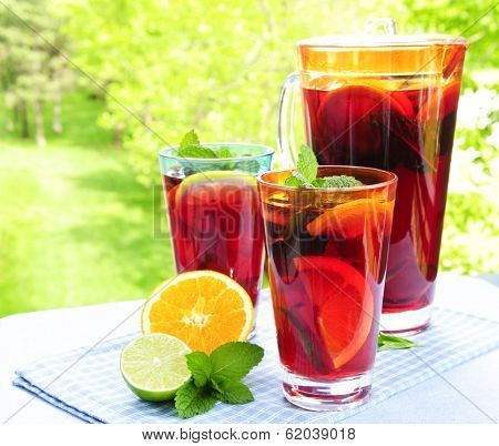 Refreshing fruit punch beverage in pitcher and glasses