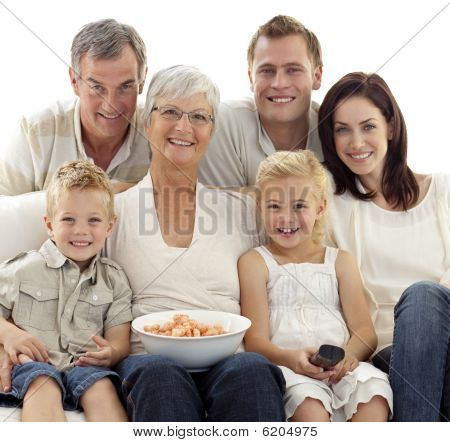 Portrait Of Family Watching Television And Eating Chips