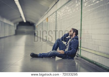 Young Man Lost In Depression Sitting On Ground Street Subway Tunnel