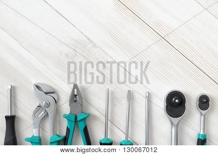 Top view of different type of constructive tools placed in a row with copy space. Construction instruments and tools. Set of tools. Home tool kit. Everyday instruments. Work stuff. Mend and repair.