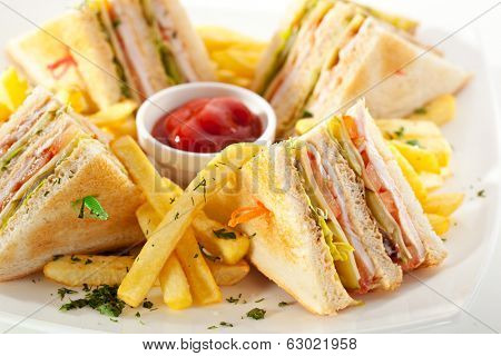 Club Sandwich with Cheese, Pickled Cucumber, Tomato and Smoked Meat. Garnished with French Fries