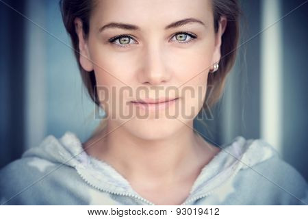 Natural portrait of a beautiful woman, authentic beauty of Caucasian female face, lite makeup on perfect skin and green eyes, genuine natural looking girl