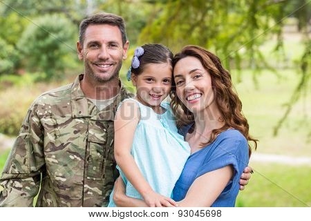 Handsome soldier reunited with family on a sunny day