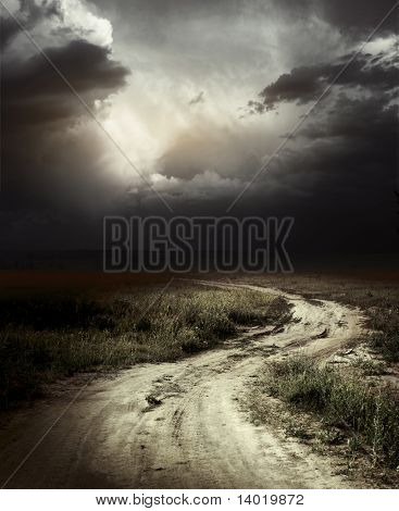 Rural road and dark storm clouds