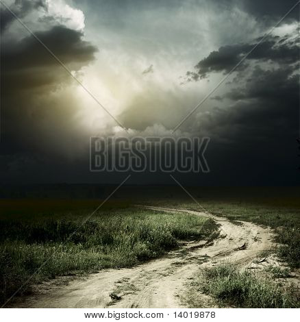 Rural road and dark storm clouds