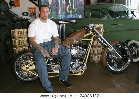 LONG BEACH - MAY 7: Jesse James poses on a motorcycle before he signs advance copies of his book 'I Am Jesse James' on May 7, 2004 at his West Coast Choppers Showroom in Long Beach, California