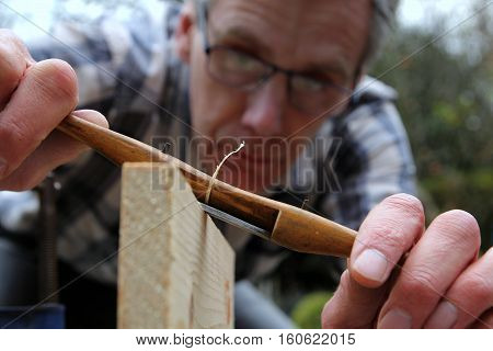 Traditional woodworker using antique boxwood spokeshave woodwork tool