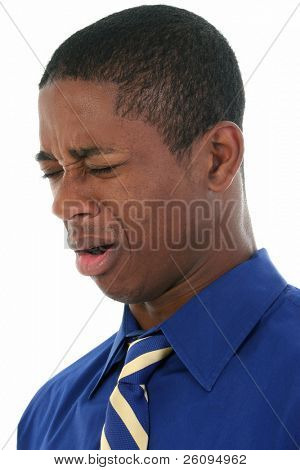 Close up headshot of African American man cringing from bad smell.  Wearing blue shirt and blue and yellow tie.