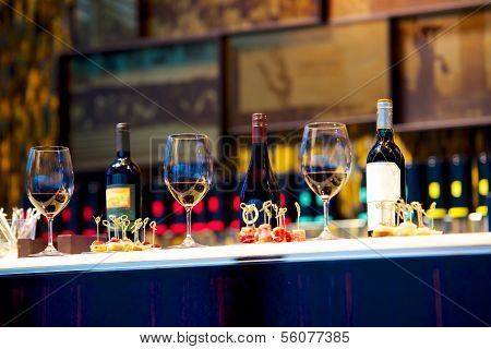 snacks and glasses of wine on counter