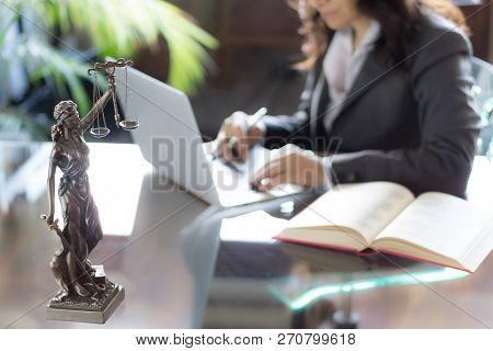 Lawyer Office. Statue Of Justice With Scales And Lawyer Working