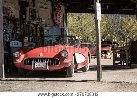 Hackberry, Arizona, United States, November 2013: Old Timer Car Fueling Up In A Vintage Service And 