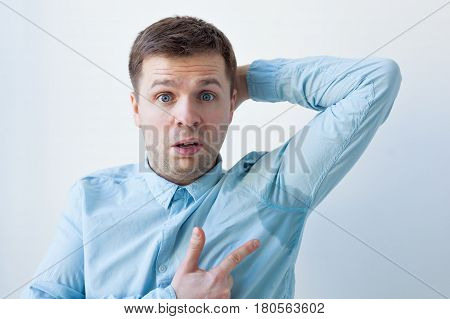 Caucasian, Young Man Is Worried And Shows Sweating Stain Problem With Sweating - Hyperhidrosis