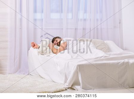 Guy On Calm Face Sleeping On White Sheets, Pillow.man Laying On Bed, Covered With Blanket, White Cur