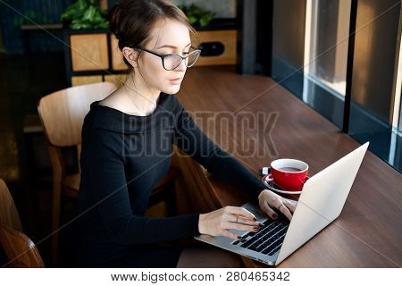 Focused Business Woman Sit On Cafe Working On Laptop, Concentrated Serious Female Working With Compu