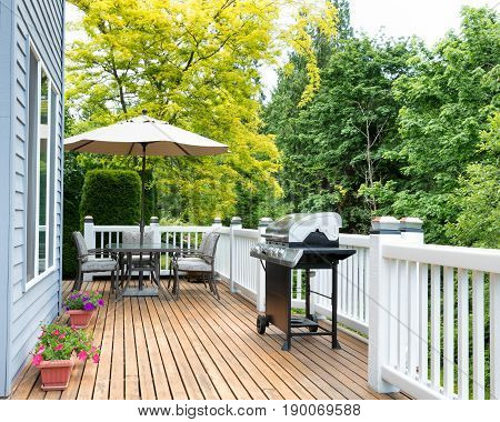 Clean outdoor cedar wooden deck and patio of home during daytime