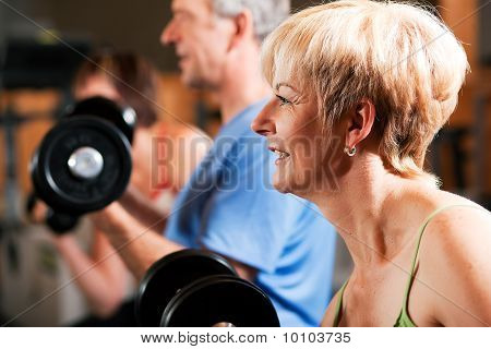 Three senior people in gym