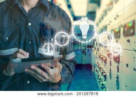 Double exposure of Engineer or Technician man using tablet in switch gear electrical room oil and gas platform or plant industrial with tools icon business and electrical industry concept.