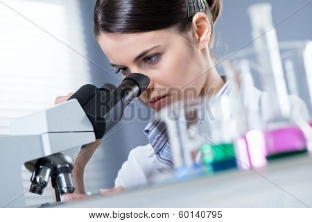 Female Researcher Using Microscope