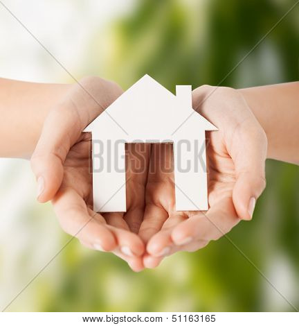 eco, bio, home, nature, power saving concept - woman hands holding house