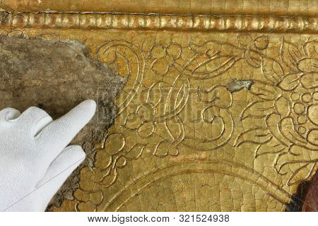 Restoration: Gold Restoration, Old Icon. Close Up. Conservation Of Paintings. Conservation Of Sculpt