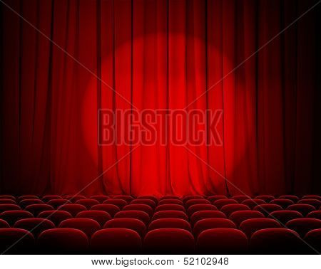 closed theater red curtains with spotlight and seats