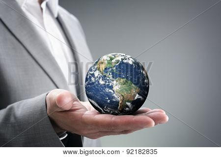 Businessman holding the world in the palm of hands concept for global business, communications, politics or environmental conservation

Earth image courtesy of Nasa at http://visibleearth.nasa.gov

