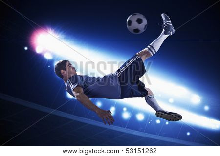 Soccer player in mid air kicking the soccer ball