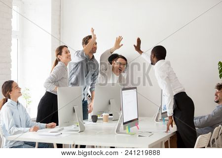 Happy Multi-ethnic Employees Sales Team Giving High Five Together Celebrating Corporate Success And 