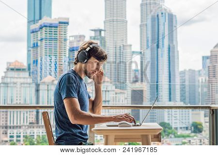 Young Man Teaches A Foreign Language Or Learns A Foreign Language On The Internet On Her Balcony Aga