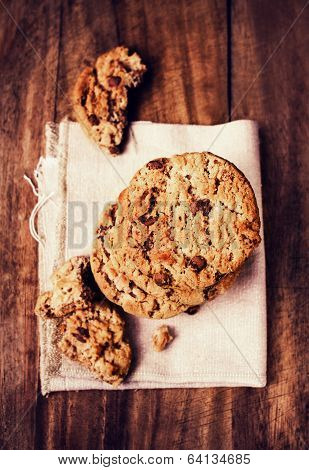 Chocolate Cookies On White Linen Napkin On Wooden Table. Chocolate Chip Cookies Shot On White Table