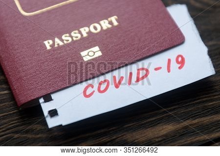 Coronavirus And Travel Concept. Note Covid-19 Coronavirus And Passport. Novel Corona Virus Outbreak.