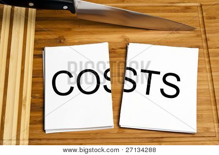 Knife cut paper with costs word