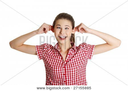 Front view portrait of a young joyful female caucasian teen making a face to the camera, on white.