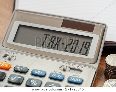 Tax Word And 2019 Number On Calculator. Business And Tax Concept. Pay Tax In 2019 Years.