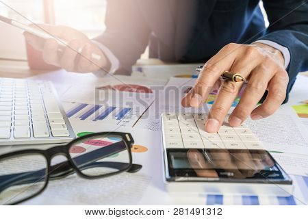 Businessman Or Accountant Working On Calculator To Calculate Business Data Concept. Accounting,inves