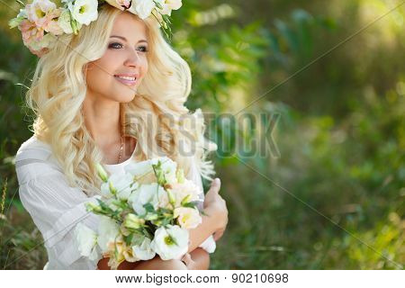 Portrait of a beautiful bride on floral swing in the Park.