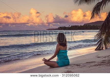 Woman Doing Yoga On Tropical Beach In Vacation. Young Woman Traveler Doing Yoga In Vacation. Travele