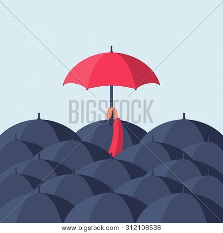 Uniqueness And Individuality. Man Holding A Red Umbrella Among People With Black Umbrellas. Standing