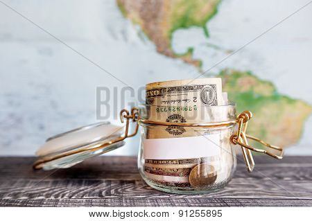 Collecting Money For Travel. Glass Tin As Moneybox With Cash Savings (banknotes And Coins)