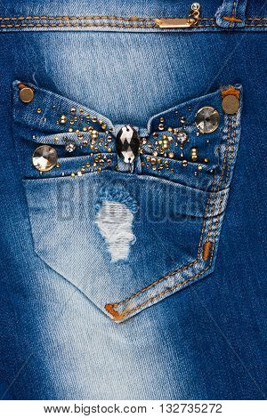 Jeans with pockets close-up decorated with rhinestones may be used as background