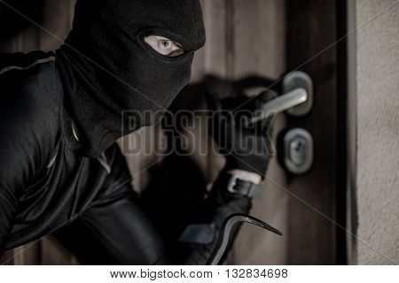 House Burglar in Mask Taking Action. Checking House Doors. House Burglary Concept.