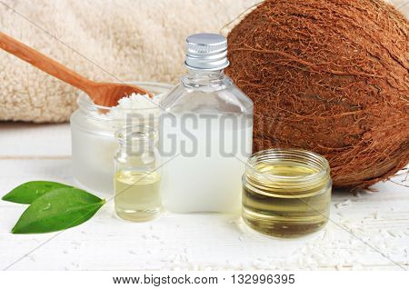 Coconut oil products cosmetic use. Skincare benefits. Bottles coconut oil, coconut milk, shavings.