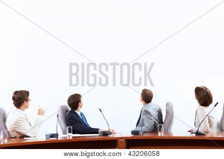 Image of businesspeople at presentation looking at screen. Space for advertisment